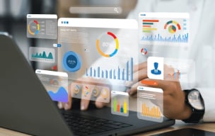 Data analyst reviewing customer data on a laptop